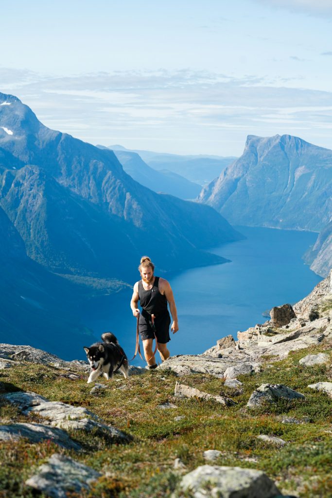 A man hiking with a dog